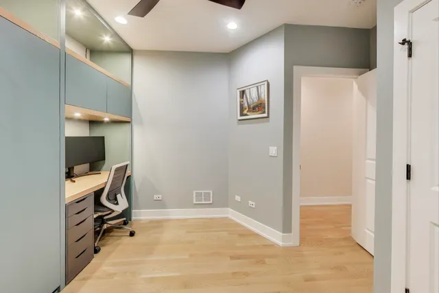 a bedroom with a bed and a painting on the wall