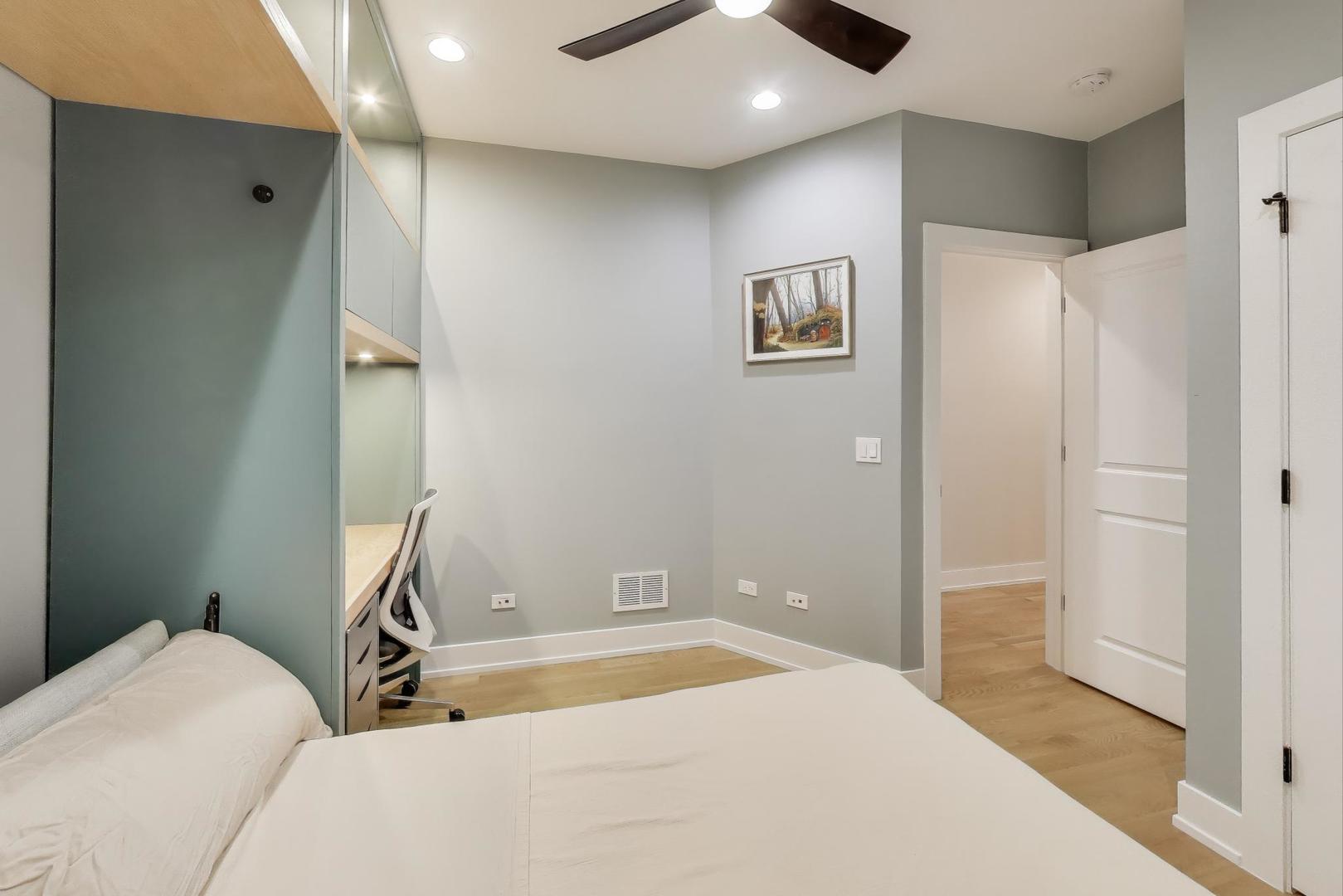 3533 North Fremont Street, Unit 2 Chicago, IL 60657 - Photo 17 of 30 a bedroom with a bed and a painting on the wall