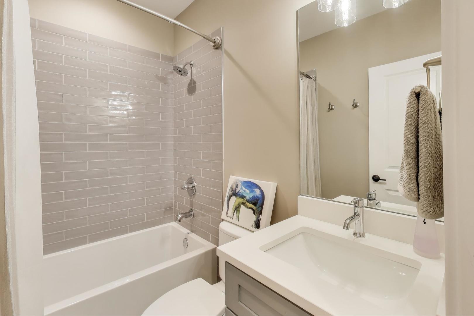 3533 North Fremont Street, Unit 2 Chicago, IL 60657 - Photo 18 of 30 a bathroom with a sink and a bathtub