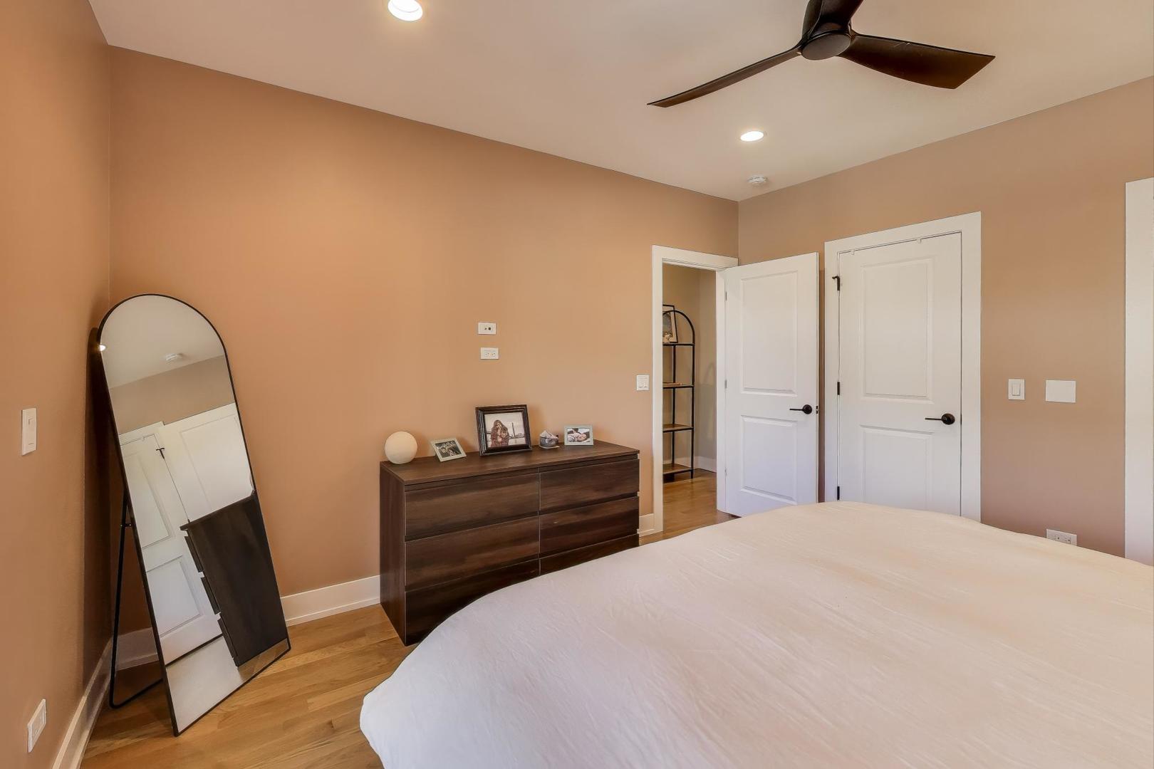 3533 North Fremont Street, Unit 2 Chicago, IL 60657 - Photo 20 of 30 a bedroom with a bed and a mirror