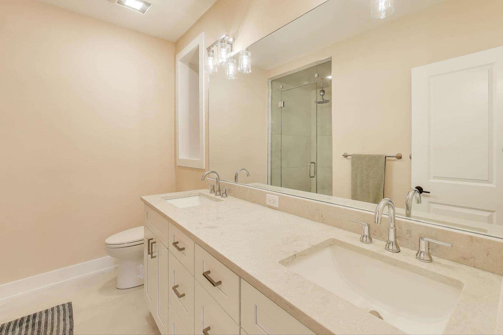 3533 North Fremont Street, Unit 2 Chicago, IL 60657 - Photo 21 of 30 a bathroom with a sink toilet and vanity
