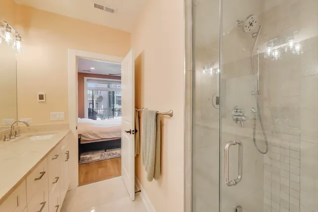 a bathroom with a glass shower door