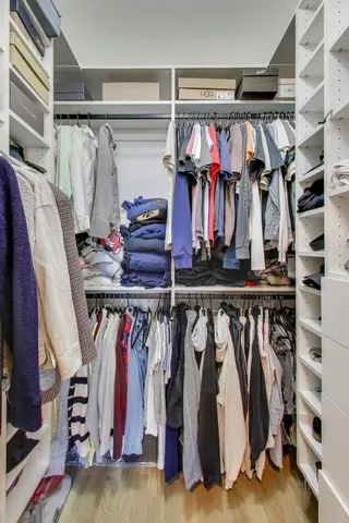 a view of a balcony with chairs and a potted plant