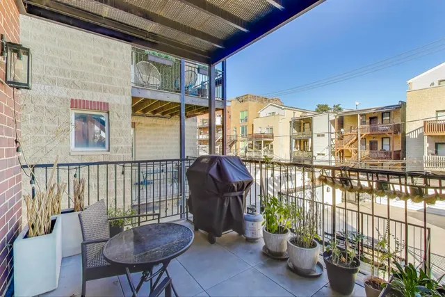 a view of staircase with furniture and lots of frames on wall