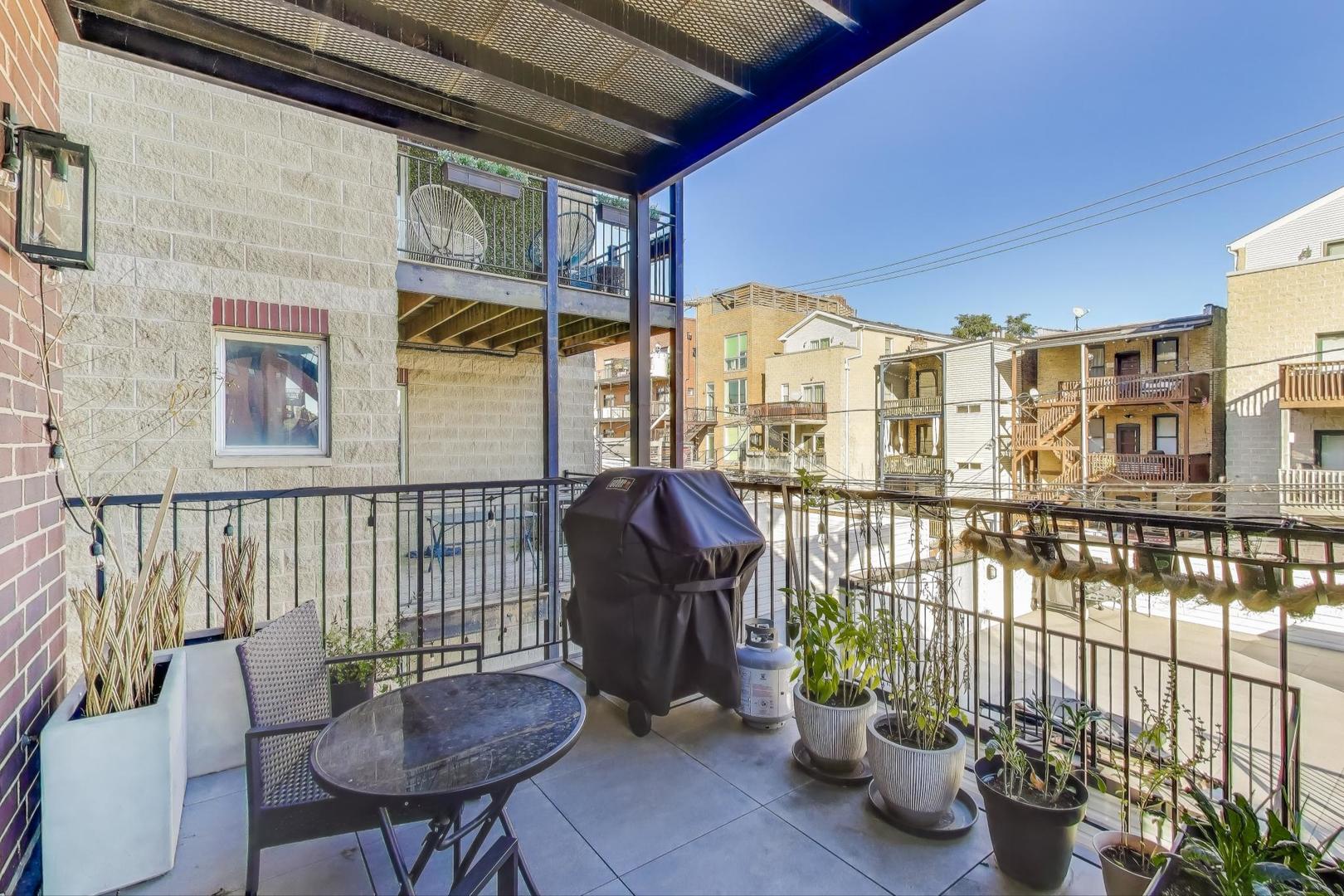 3533 North Fremont Street, Unit 2 Chicago, IL 60657 - Photo 25 of 30 a view of a balcony with chairs and a potted plant
