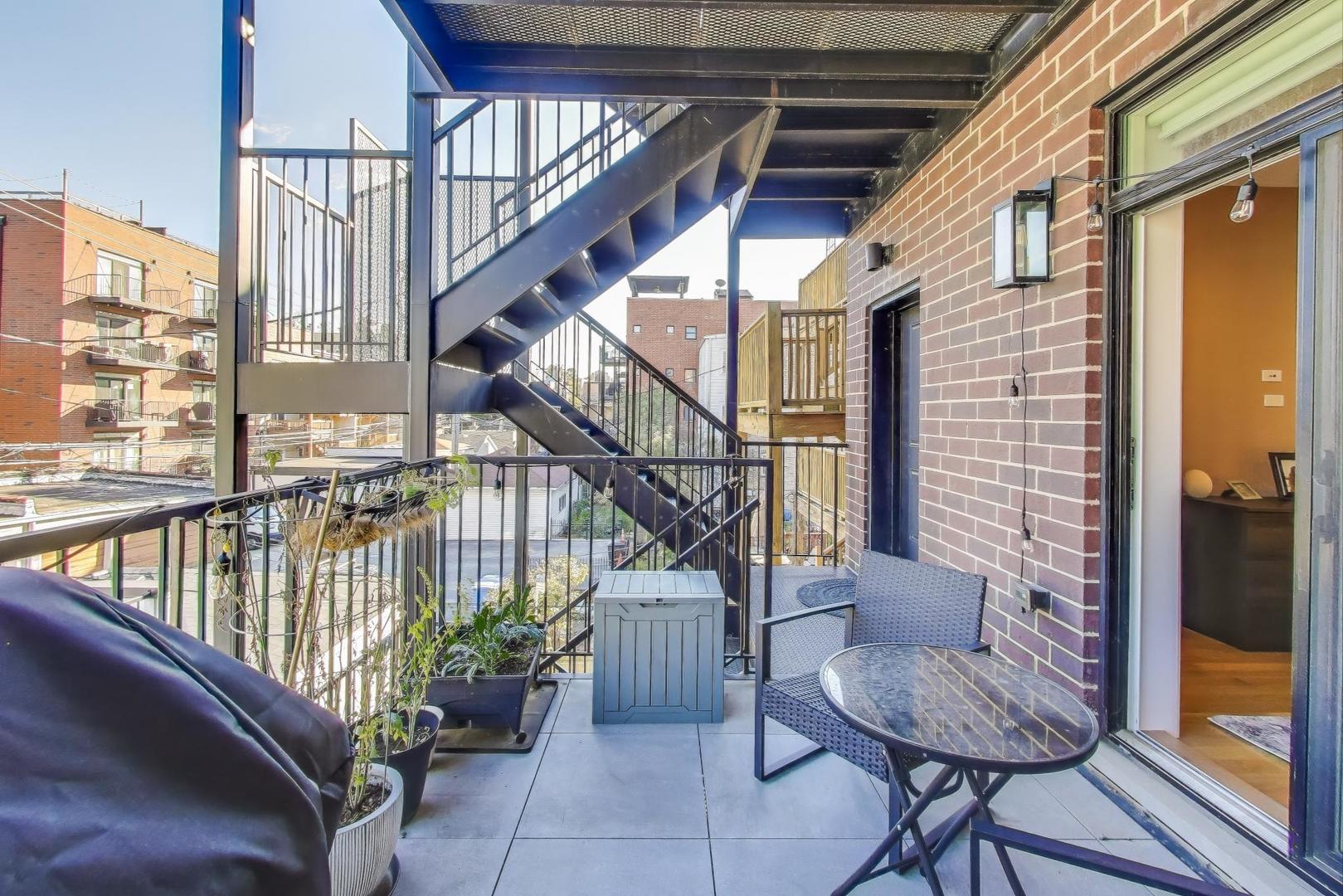 3533 North Fremont Street, Unit 2 Chicago, IL 60657 - Photo 26 of 30 a view of staircase with furniture and lots of frames on wall