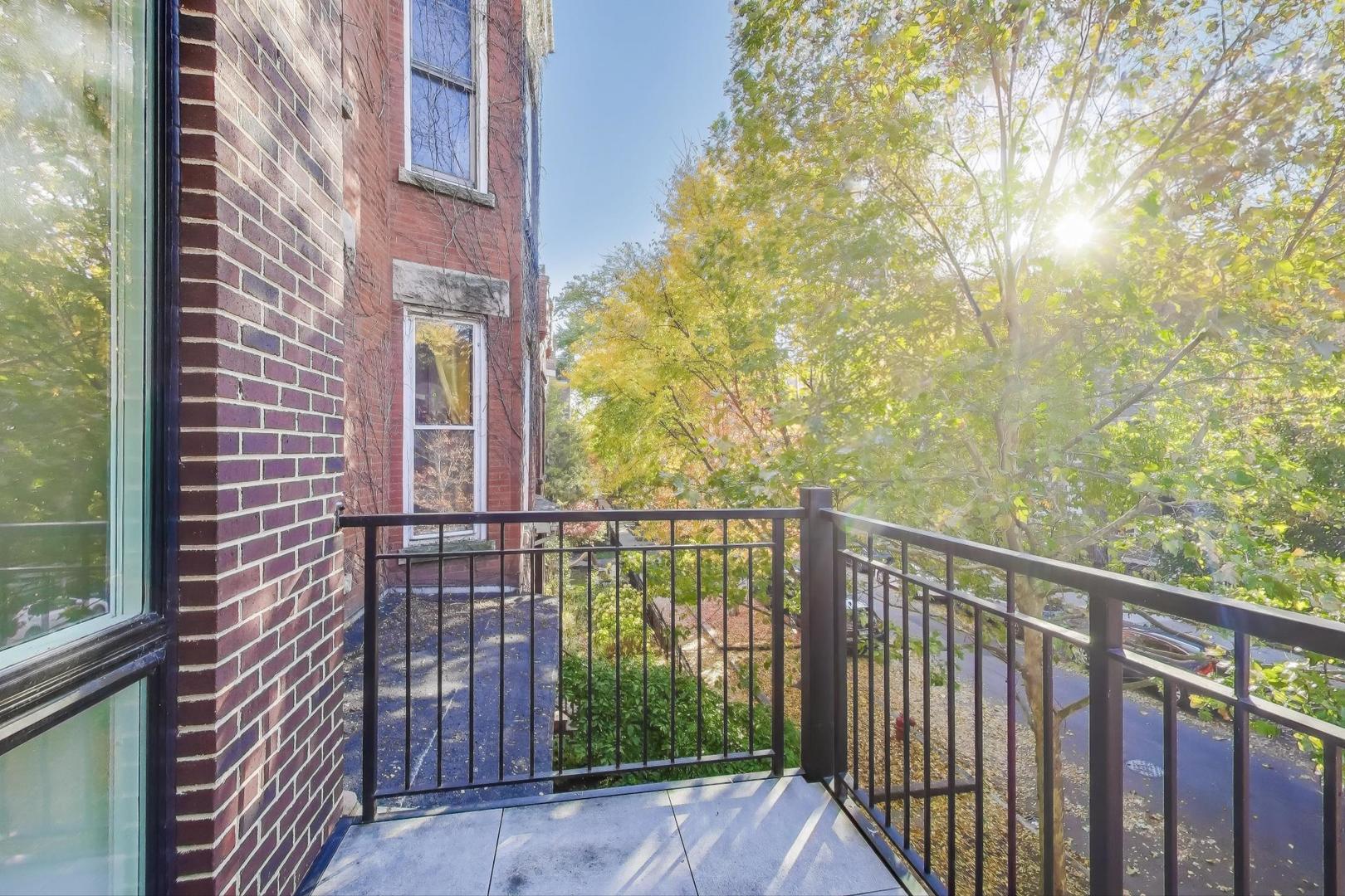 3533 North Fremont Street, Unit 2 Chicago, IL 60657 - Photo 27 of 30 a view of a balcony with a tree