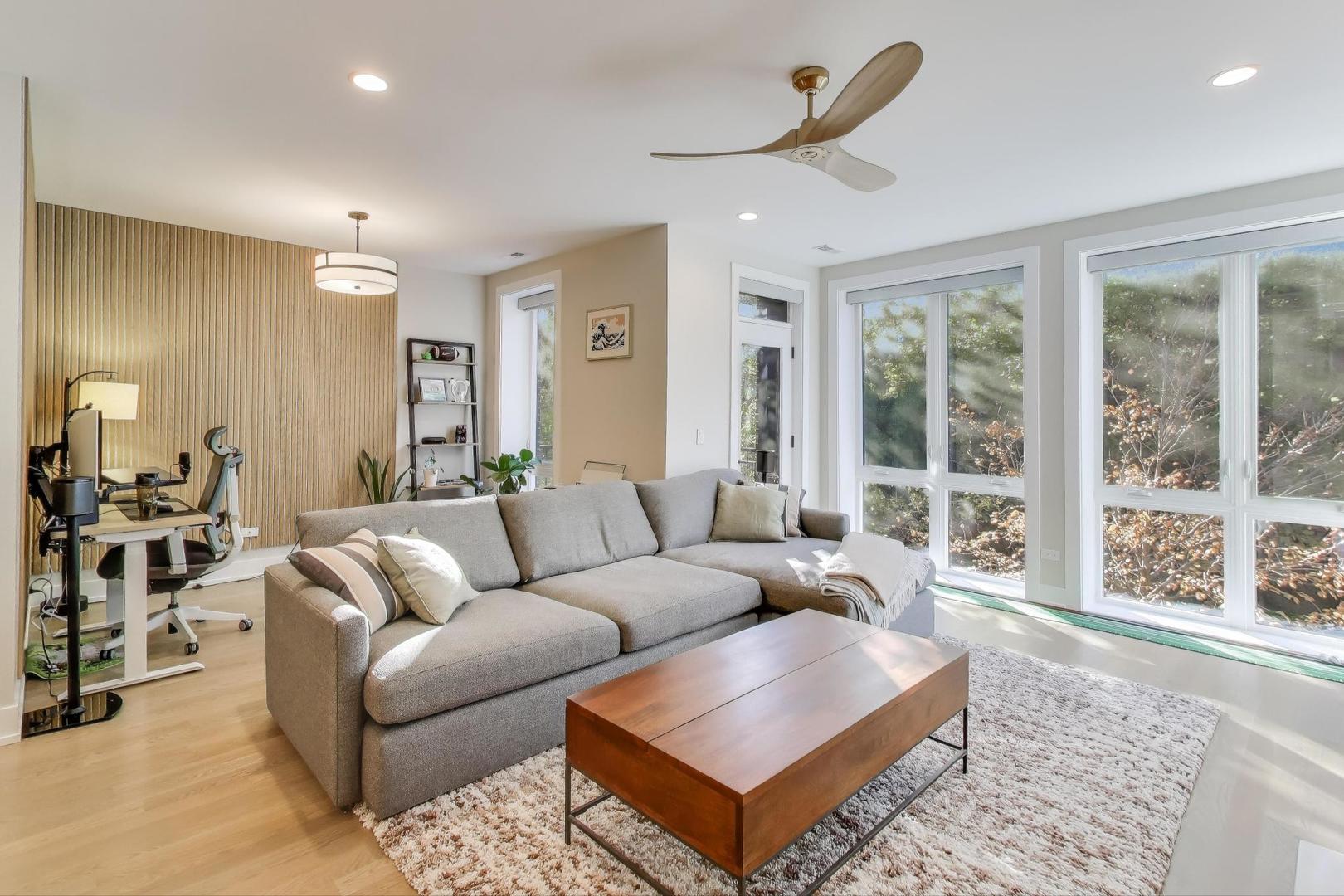 3533 North Fremont Street, Unit 2 Chicago, IL 60657 - Photo 3 of 30 a living room with furniture a large window and a rug