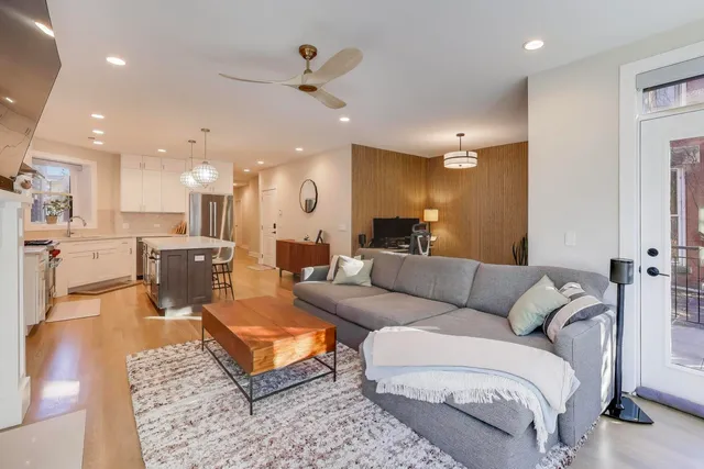 a living room with furniture and kitchen view