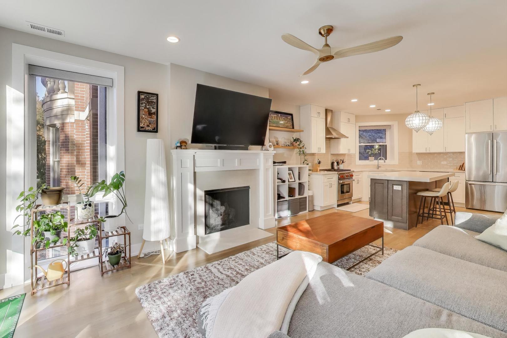 3533 North Fremont Street, Unit 2 Chicago, IL 60657 - Photo 5 of 30 a living room with furniture a flat screen tv and a fireplace