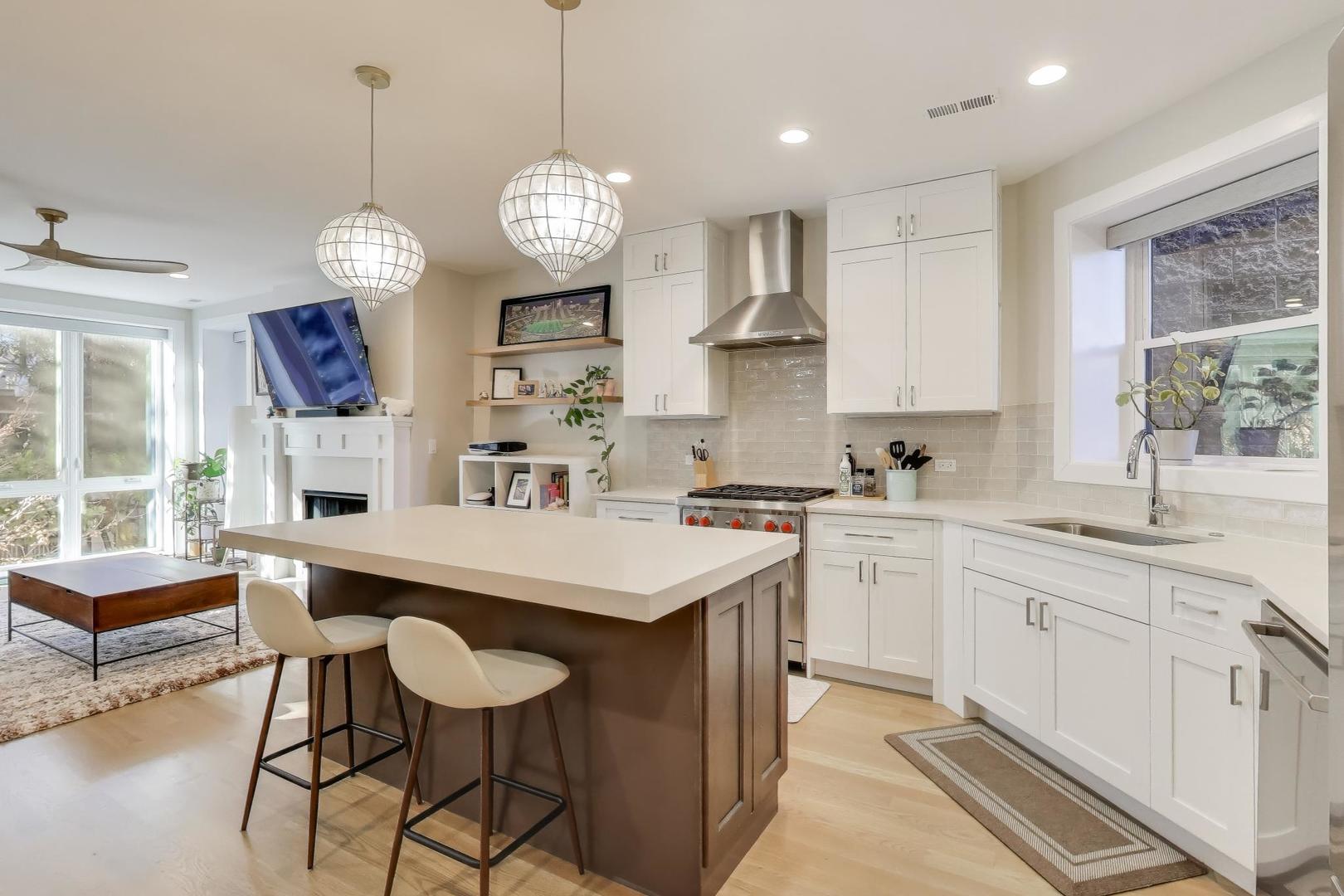 3533 North Fremont Street, Unit 2 Chicago, IL 60657 - Photo 9 of 30 a large kitchen with a center island and appliances