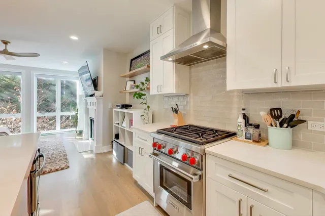 a kitchen with stove and cabinets