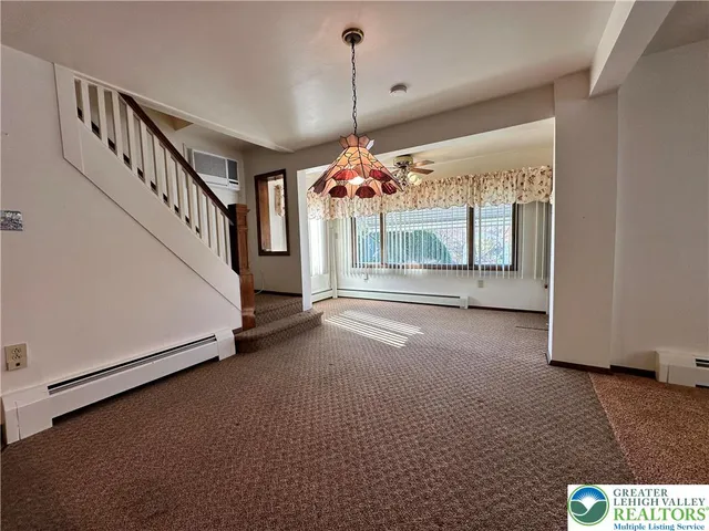 a view of a room with window and stairs