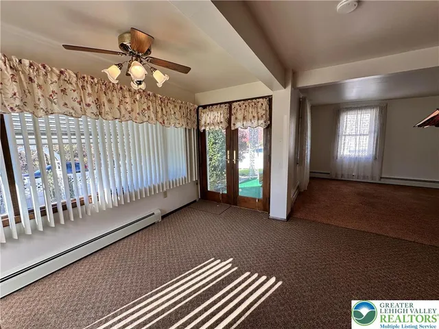 a view of entryway and hall with a chandelier