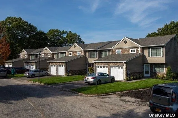 a front view of a house with a garden and plants