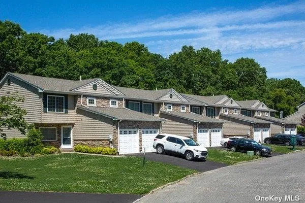 a front view of a house with a garden and parking space