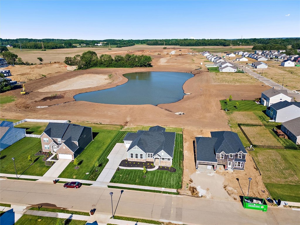 407 South Landon Lane Springfield, OH 45502 - Photo 24 of 30 An aerial perspective showcases a developing neighborhood with new homes adjacent to a scenic pond.