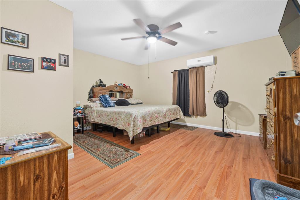 447 Masthead Road Gun Barrel City, TX 75156 - Photo 12 of 27 a bedroom with a bed and wooden floor
