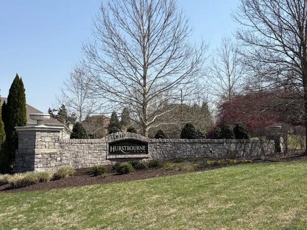 a living room with furniture and a large window with kitchen view