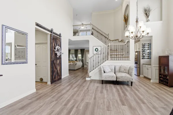 a living room with furniture and a book shelf