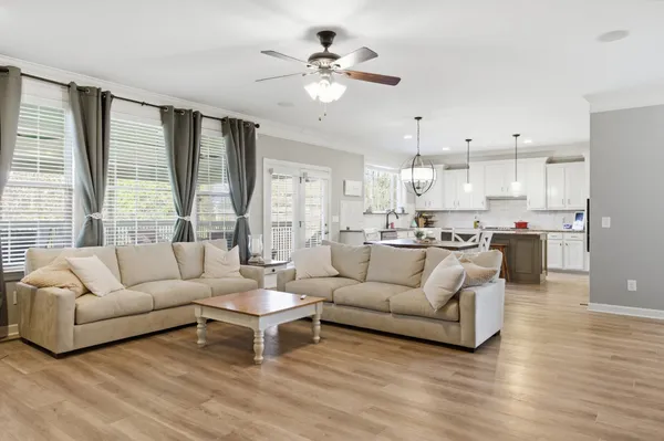 a living room with furniture window and a flat screen tv