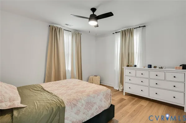 a bedroom with a bed and a dresser in it