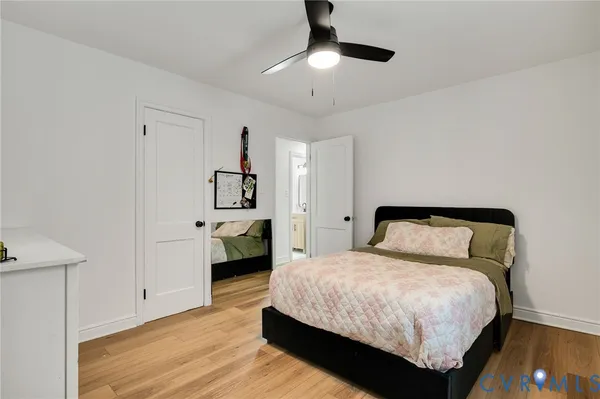 a bedroom with a large bed and a chandelier