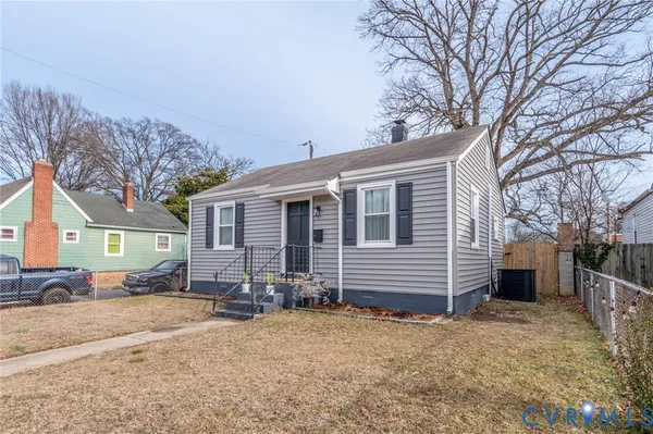 a front view of a house with a yard covered in snow