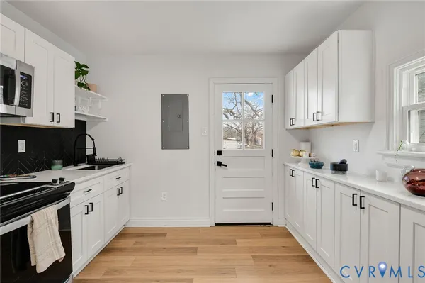 a kitchen with a sink stove and cabinets