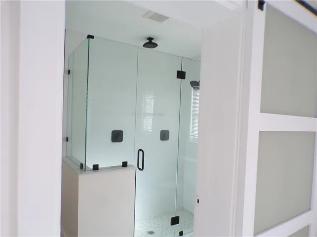 a bathroom with a tub shower vanity and a sink