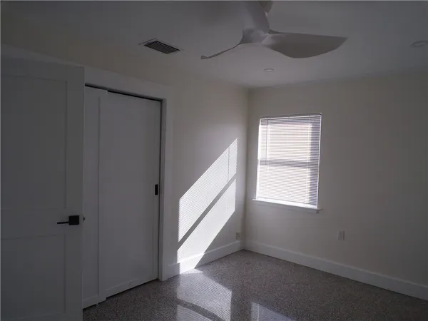 a view of an empty room with a window