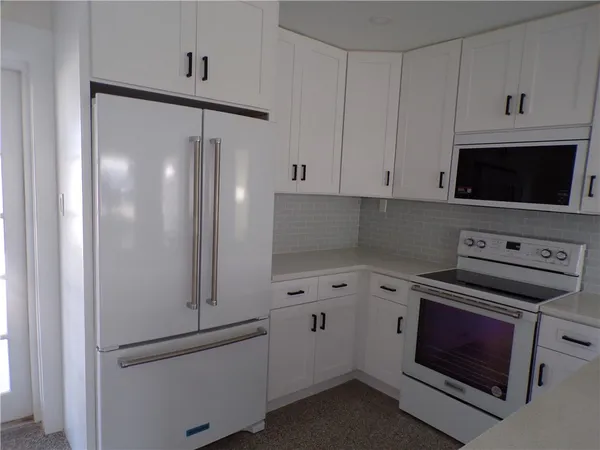 a kitchen with cabinets and steel stainless steel appliances