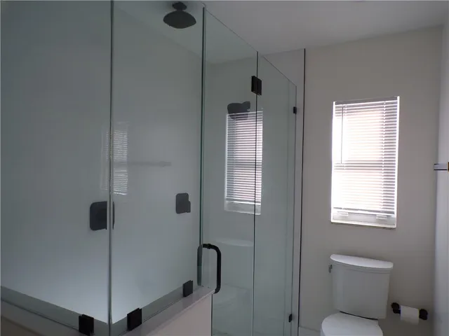 a bathroom with a shower and toilet