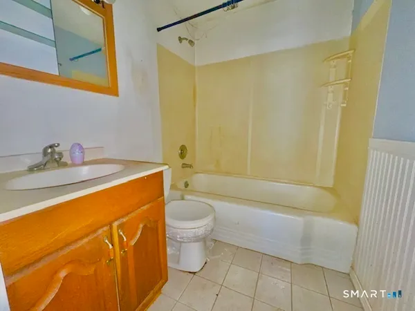 a bathroom with a sink a toilet and bathtub