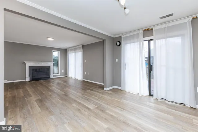 wooden floor in an empty room with a fireplace