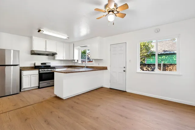a view of empty room with wooden floor