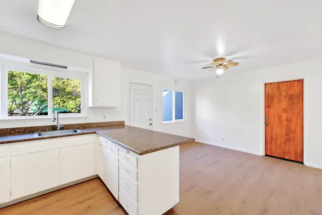 a kitchen with stainless steel appliances granite countertop a stove a refrigerator and a sink