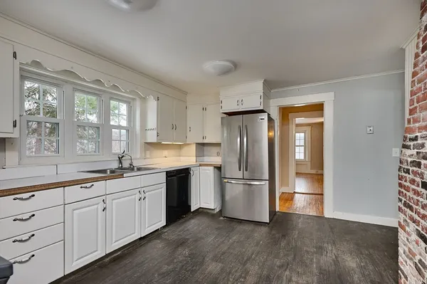 a kitchen with a refrigerator and a sink