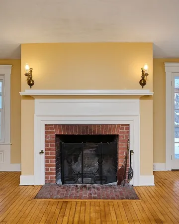 a living room with a fireplace and a table