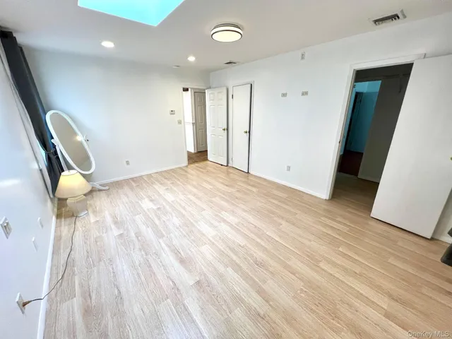 a view of an empty room and wooden floor