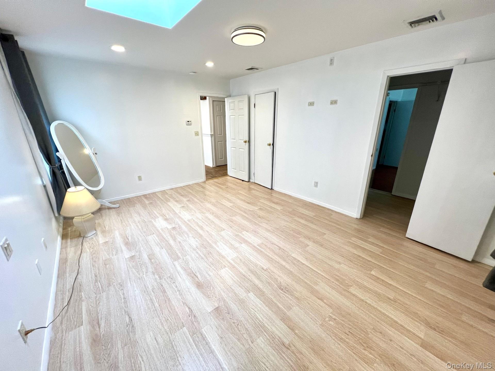 2341 Westley Road Westbury, NY 11590 - Photo 6 of 15 a view of an empty room and wooden floor