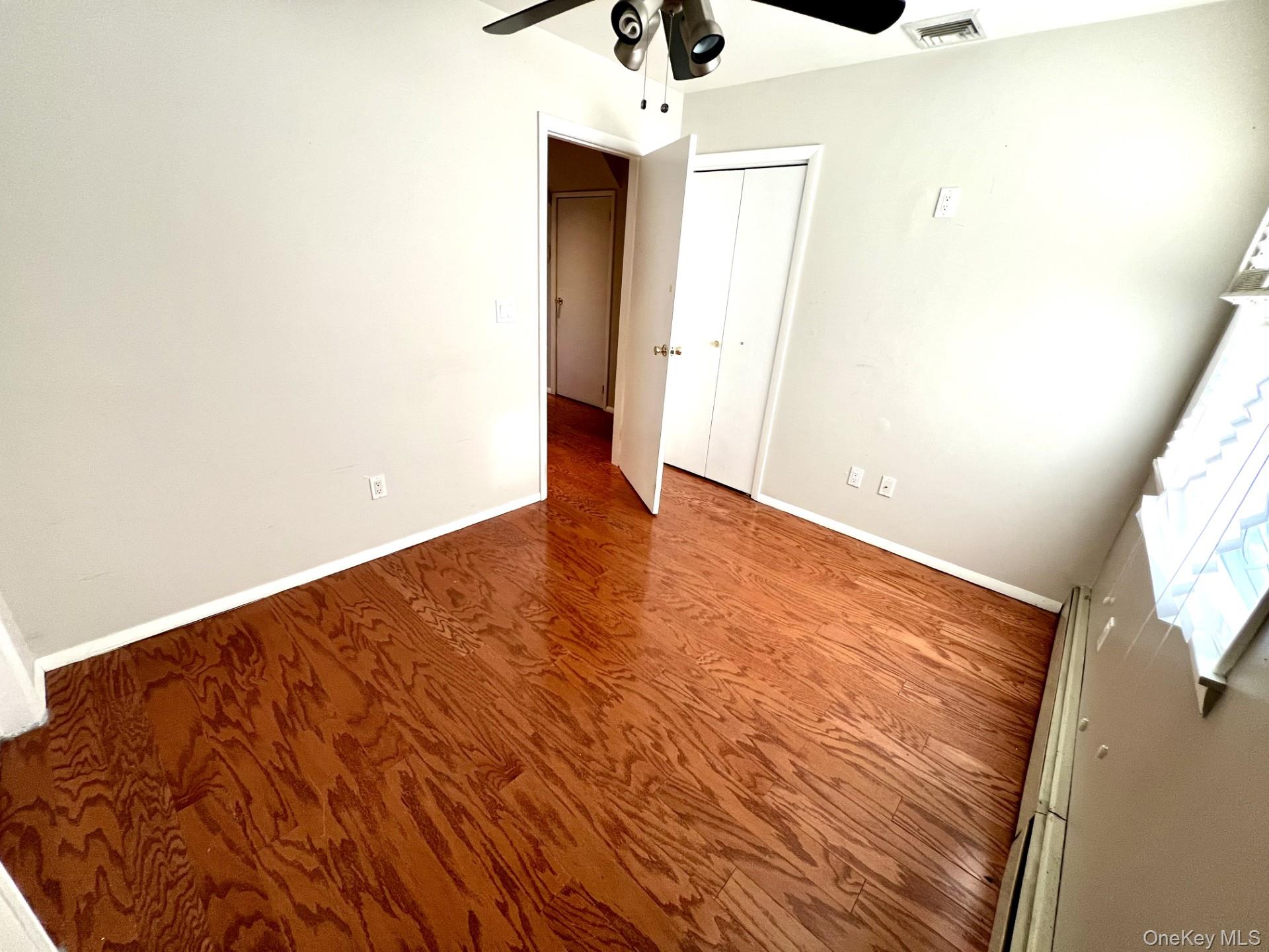 2341 Westley Road Westbury, NY 11590 - Photo 9 of 15 a view of an empty room with wooden floor