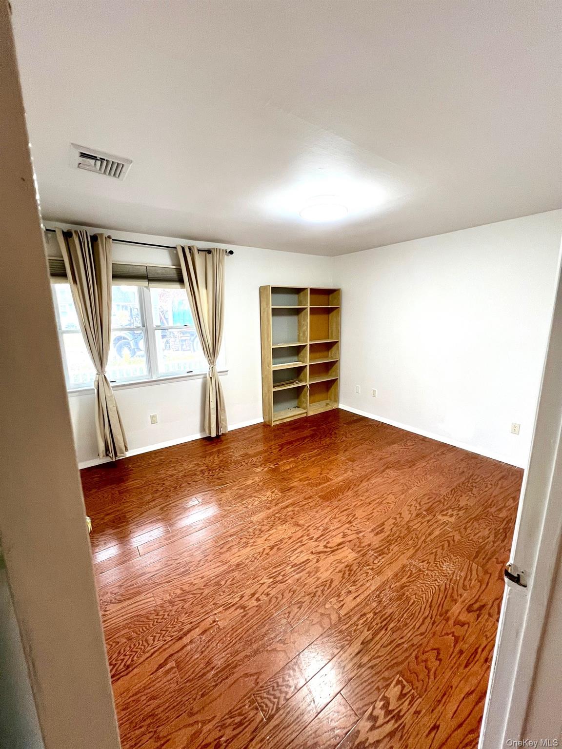 2341 Westley Road Westbury, NY 11590 - Photo 10 of 15 an empty room with windows