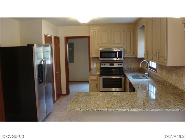 10319 North Donegal Road Chesterfield, VA 23832 - Photo 4 of 9 a kitchen with a refrigerator and a sink
