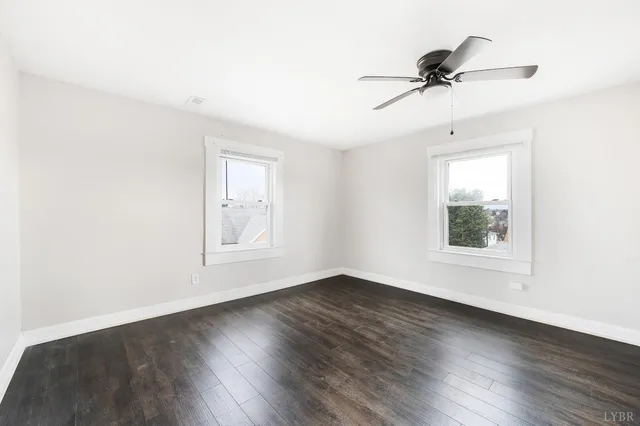 a bathroom with a toilet sink vanity and mirror