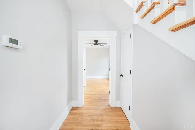 a view of entryway and hall with wooden floor