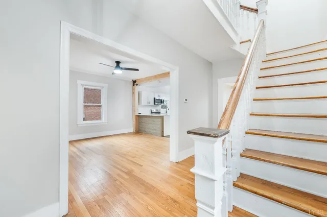 a view of entryway and hall with wooden floor