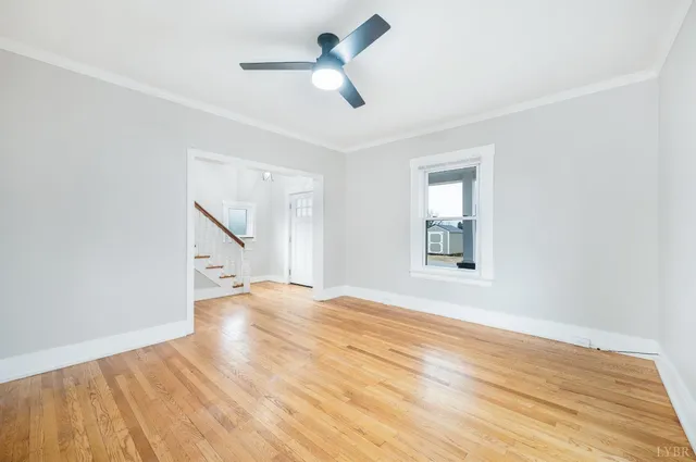 a view of a kitchen with wooden floor and a window
