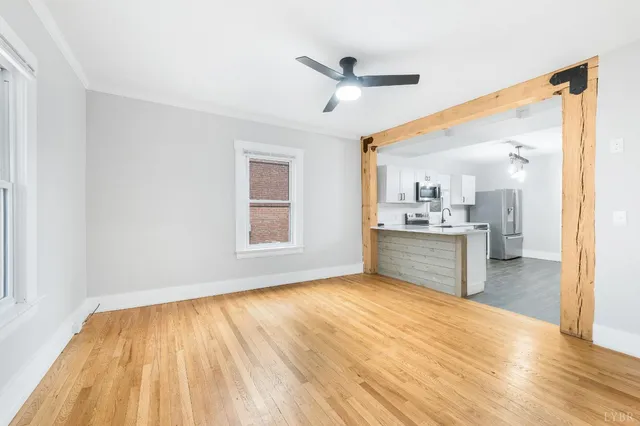 a kitchen with a sink a refrigerator and cabinets