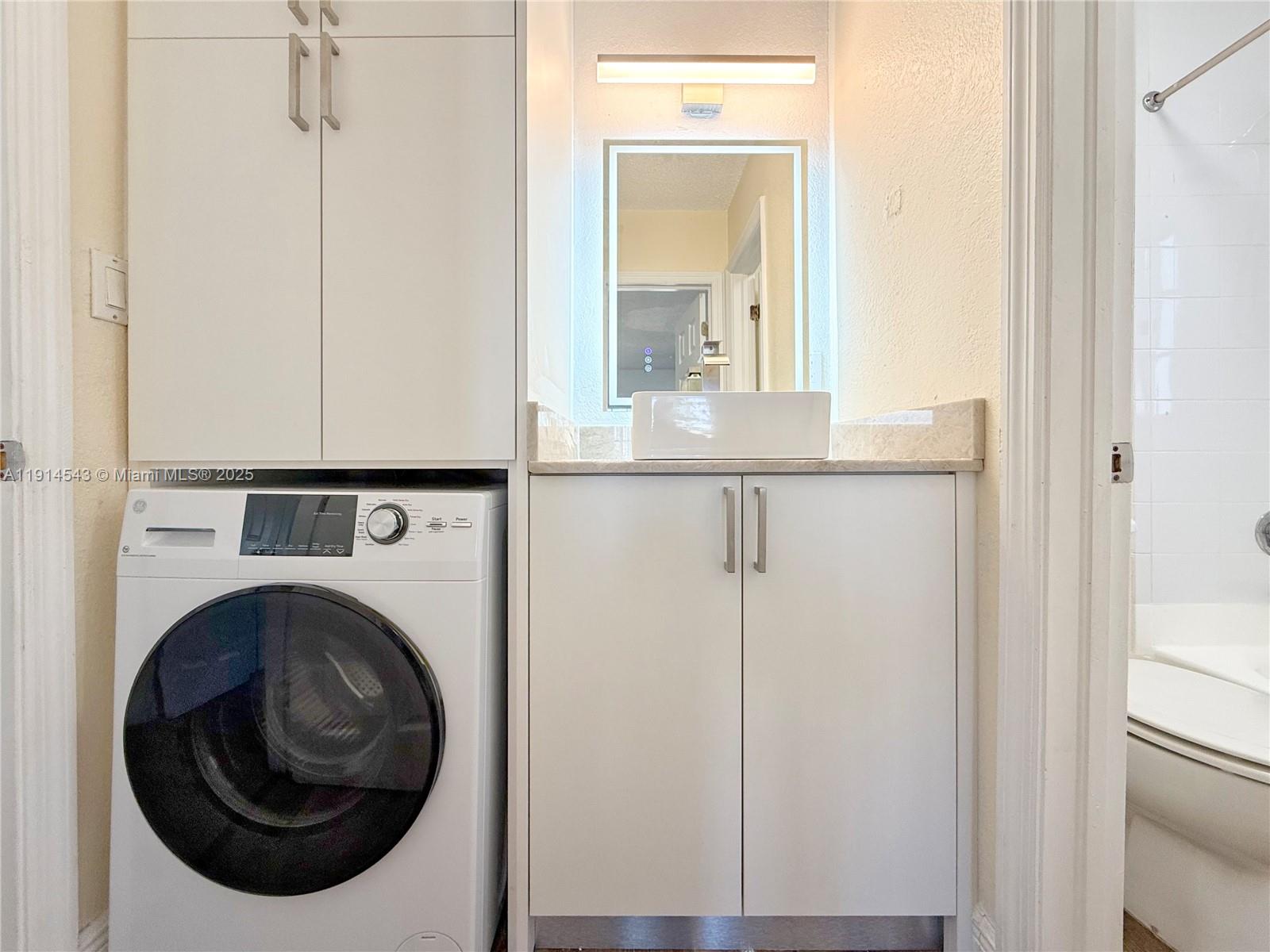 5231 Geneva Court, Unit 307 Doral, FL 33166 - Photo 12 of 26 a close view of a utility room with washer and dryer